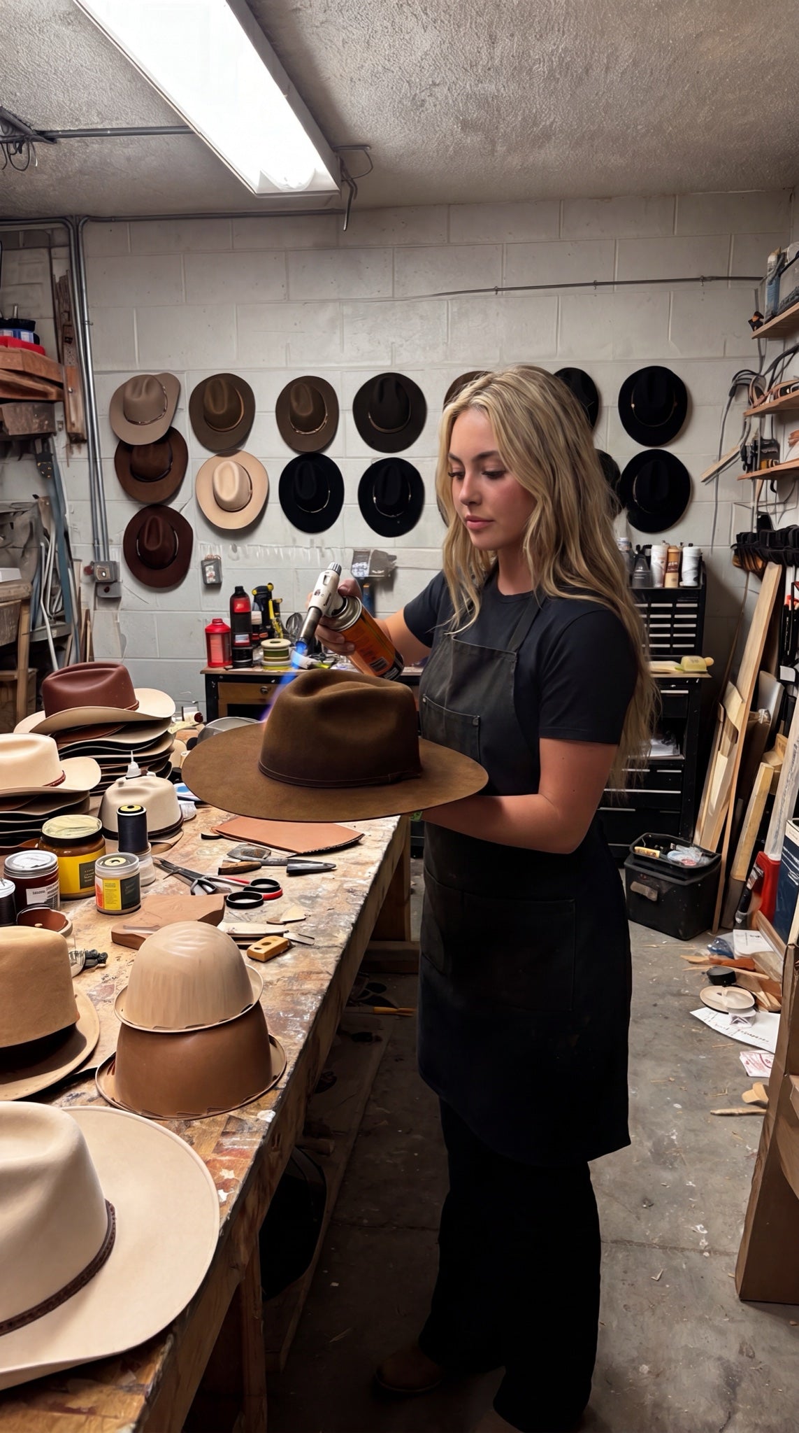 Katie shaping a hat in her workshop